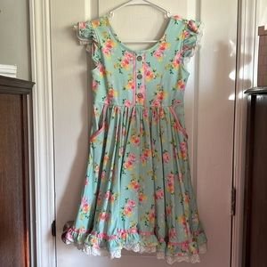 blue dress, yellow, orange and pink white trimming brown buttons, pink ribbon